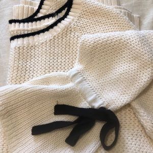 White sweater with black bow detail